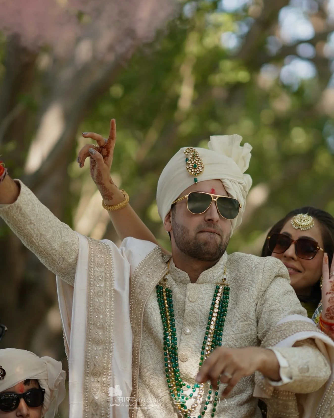 Groom in an ivory wedding safa with emerald jewellery for Mussoorie
